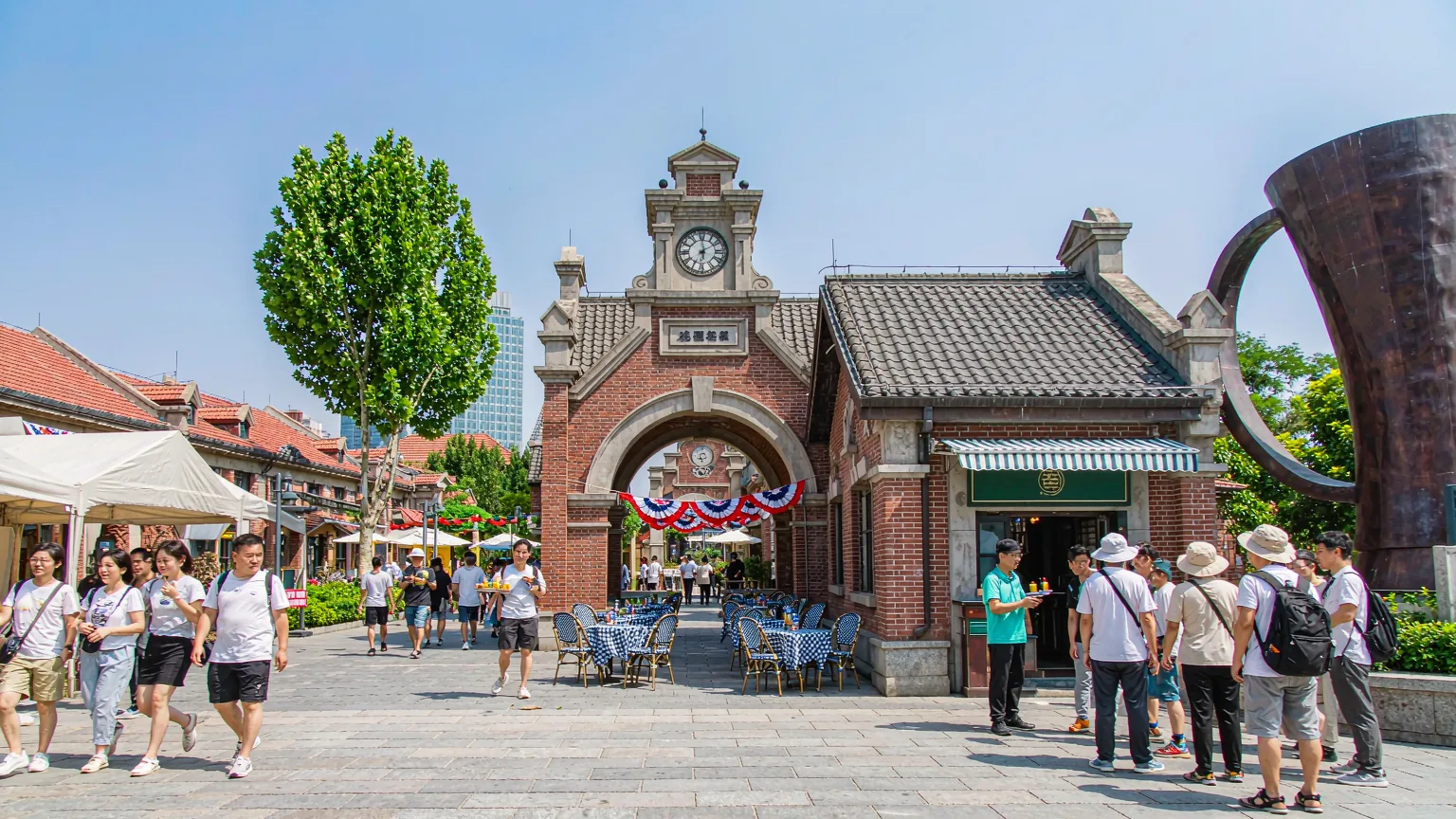 Visitors entering Tsingtao Beer Museum with guide through red-brick archway