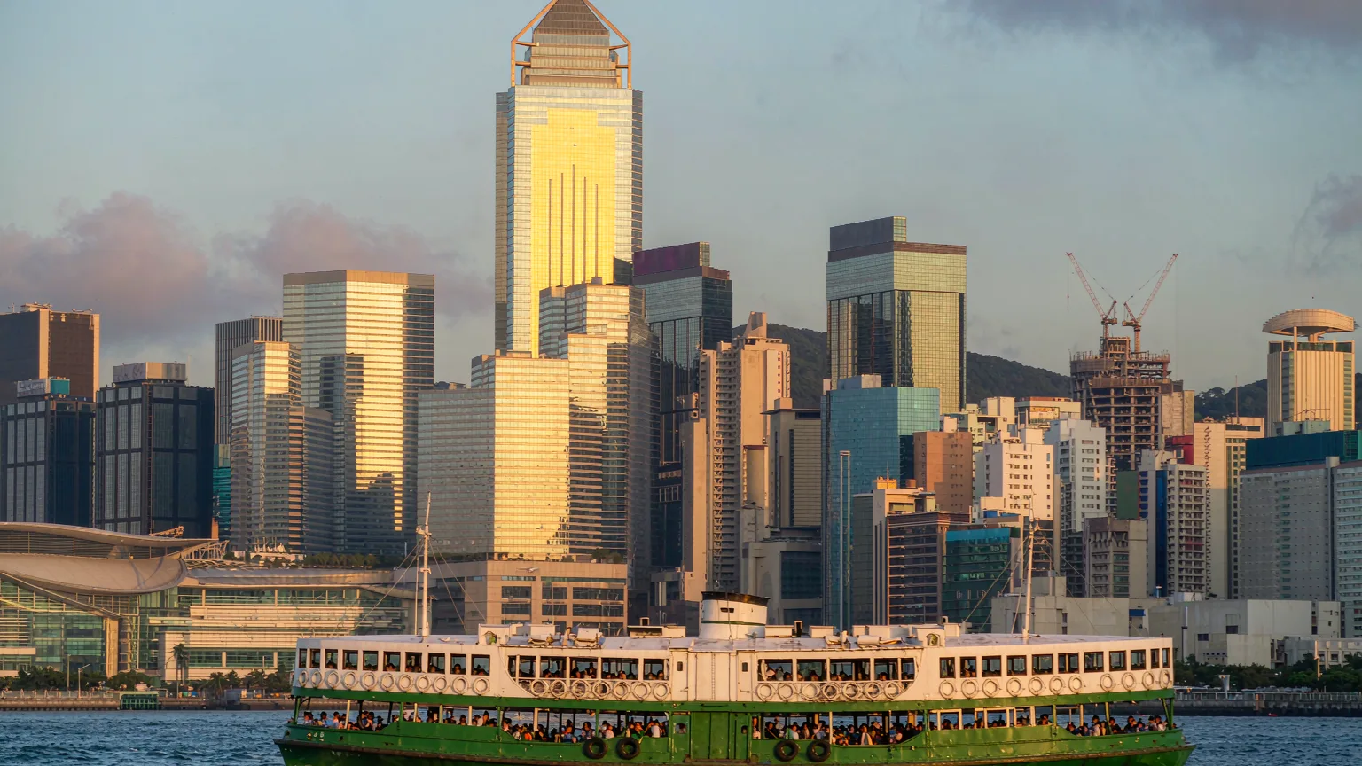 Star Ferry crossing Victoria Harbour with Hong Kong skyline behind