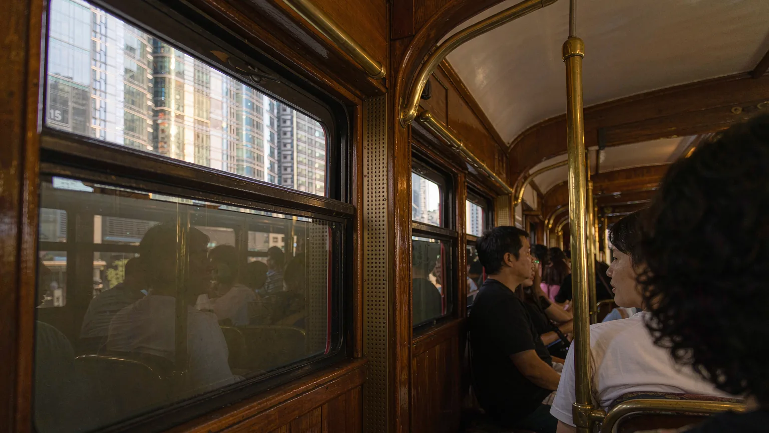 Interior detail of historic Peak Tram with wooden seats and brass