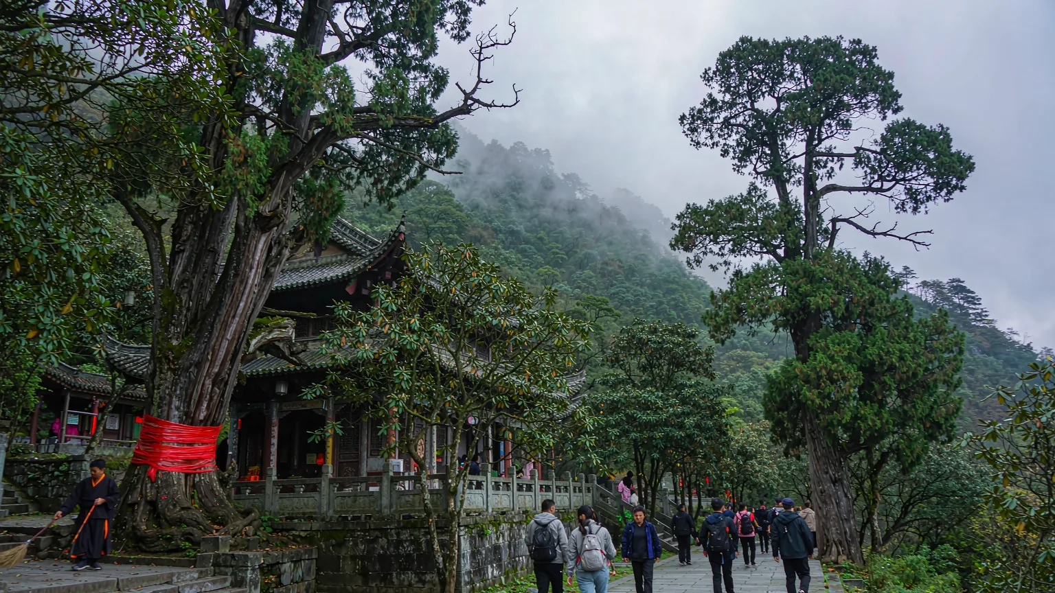Visitors walking along stone path to Wannian Temple entrance