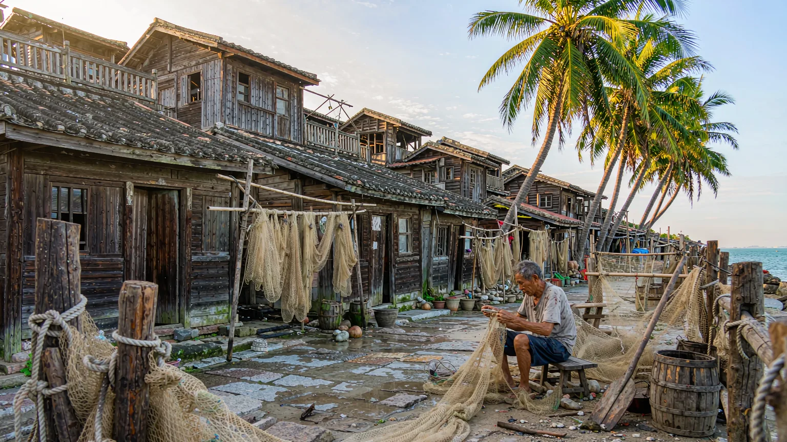 Fishing village on West Island with nets and palm trees