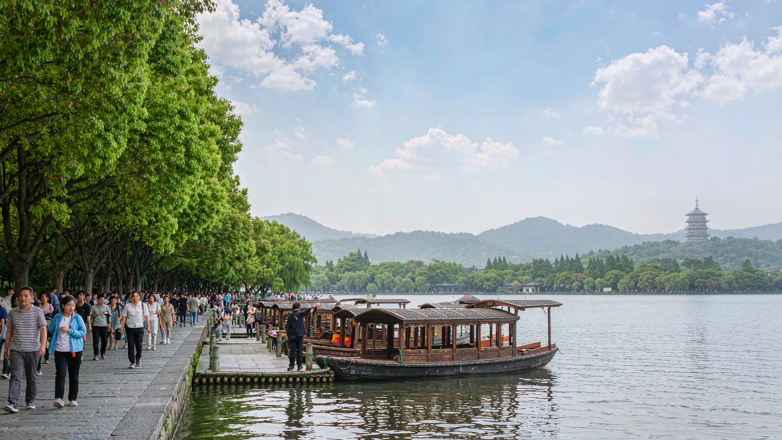 Tourists walking on Su Causeway with boats and lake views