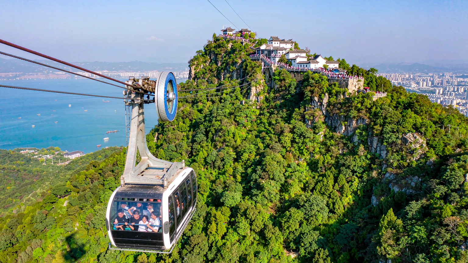 Cable car ascending to Dragon Gate with lake view below