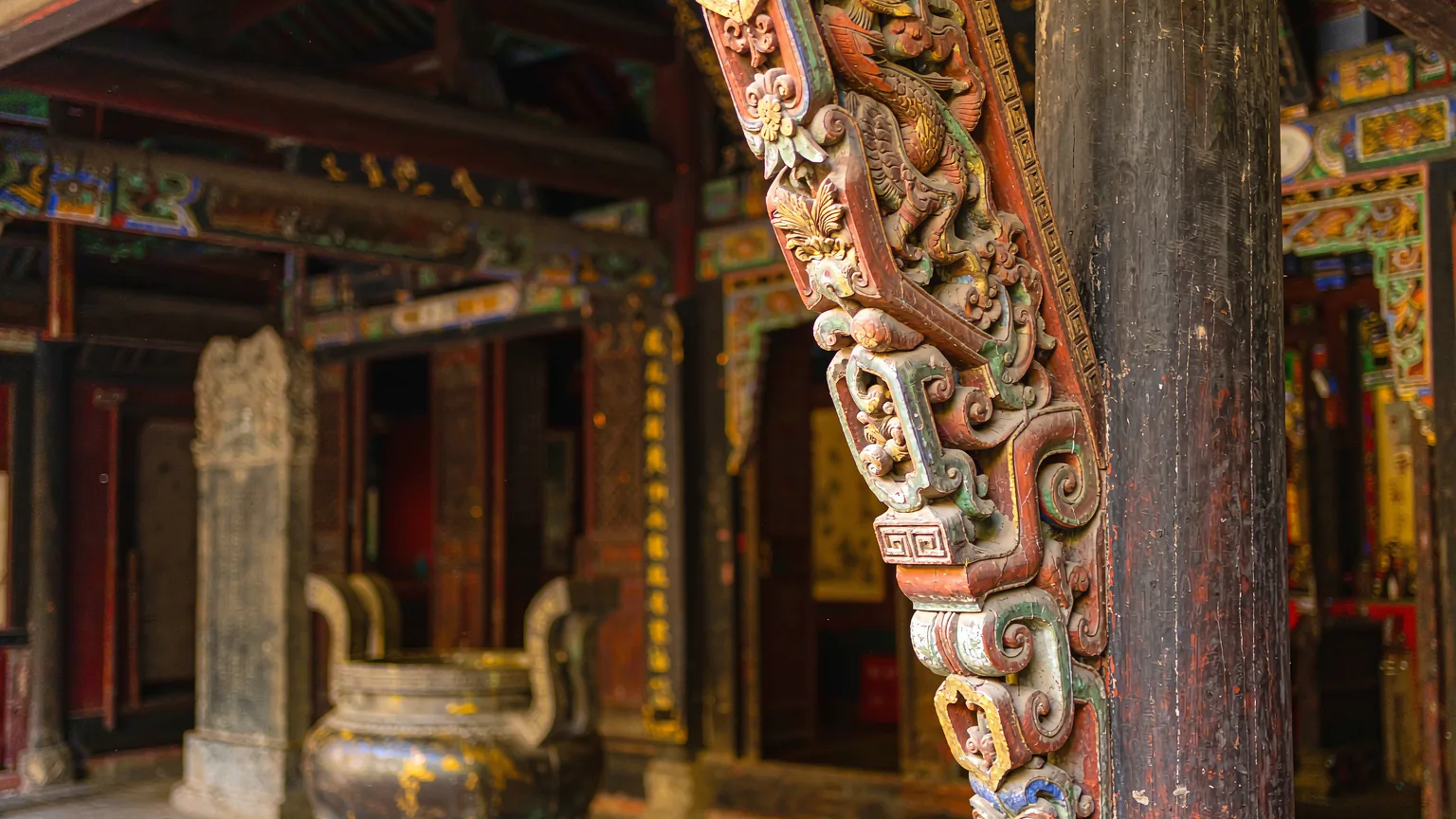 Detailed carvings on temple pillar at White Emperor City