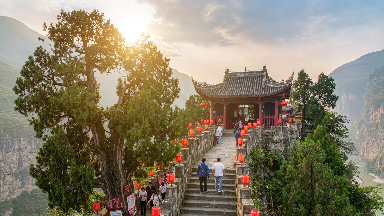 Tourists climbing stone steps to White Emperor City entrance