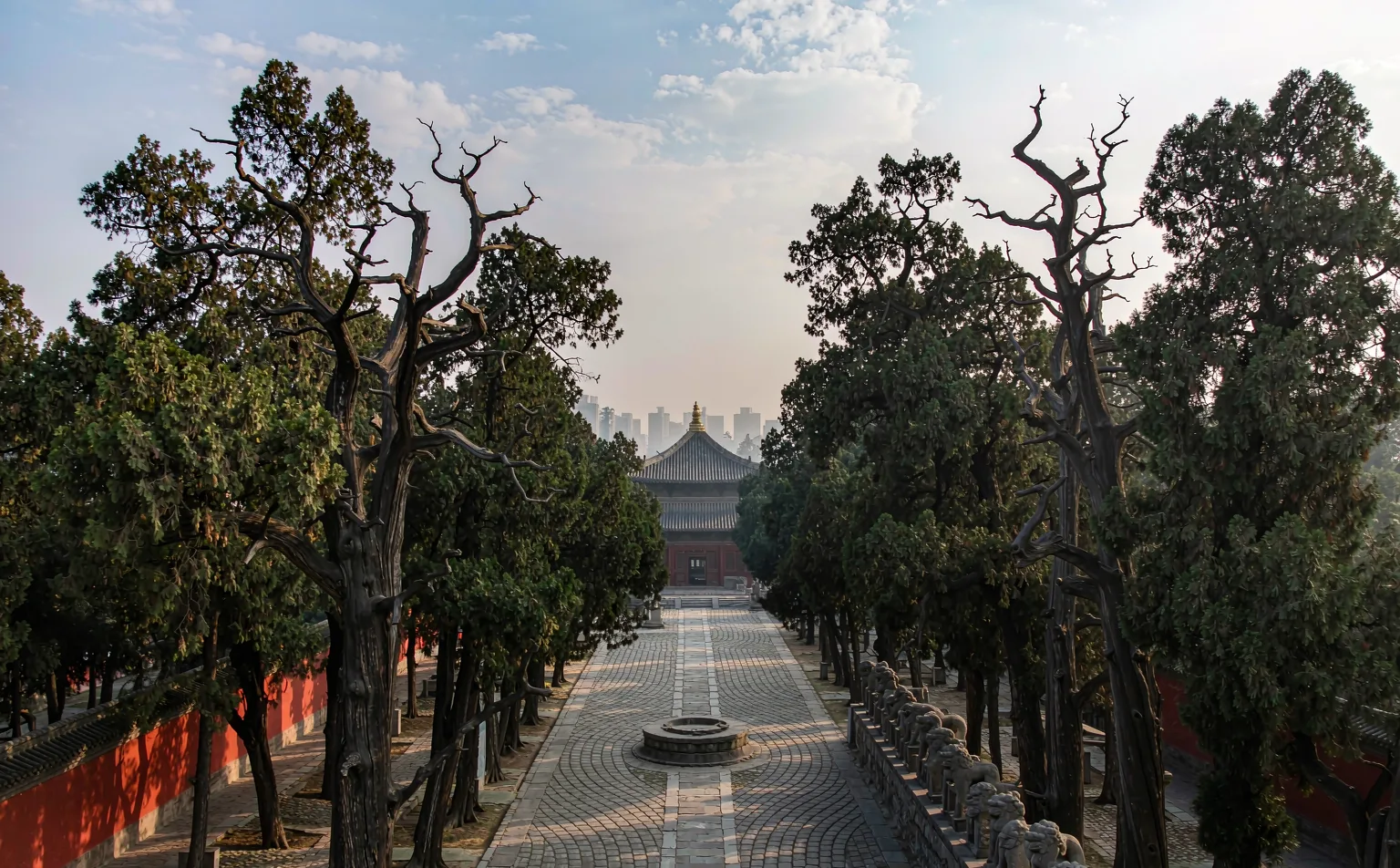 Cypress-lined path with red walls and stone statues at Wuhou Shrine