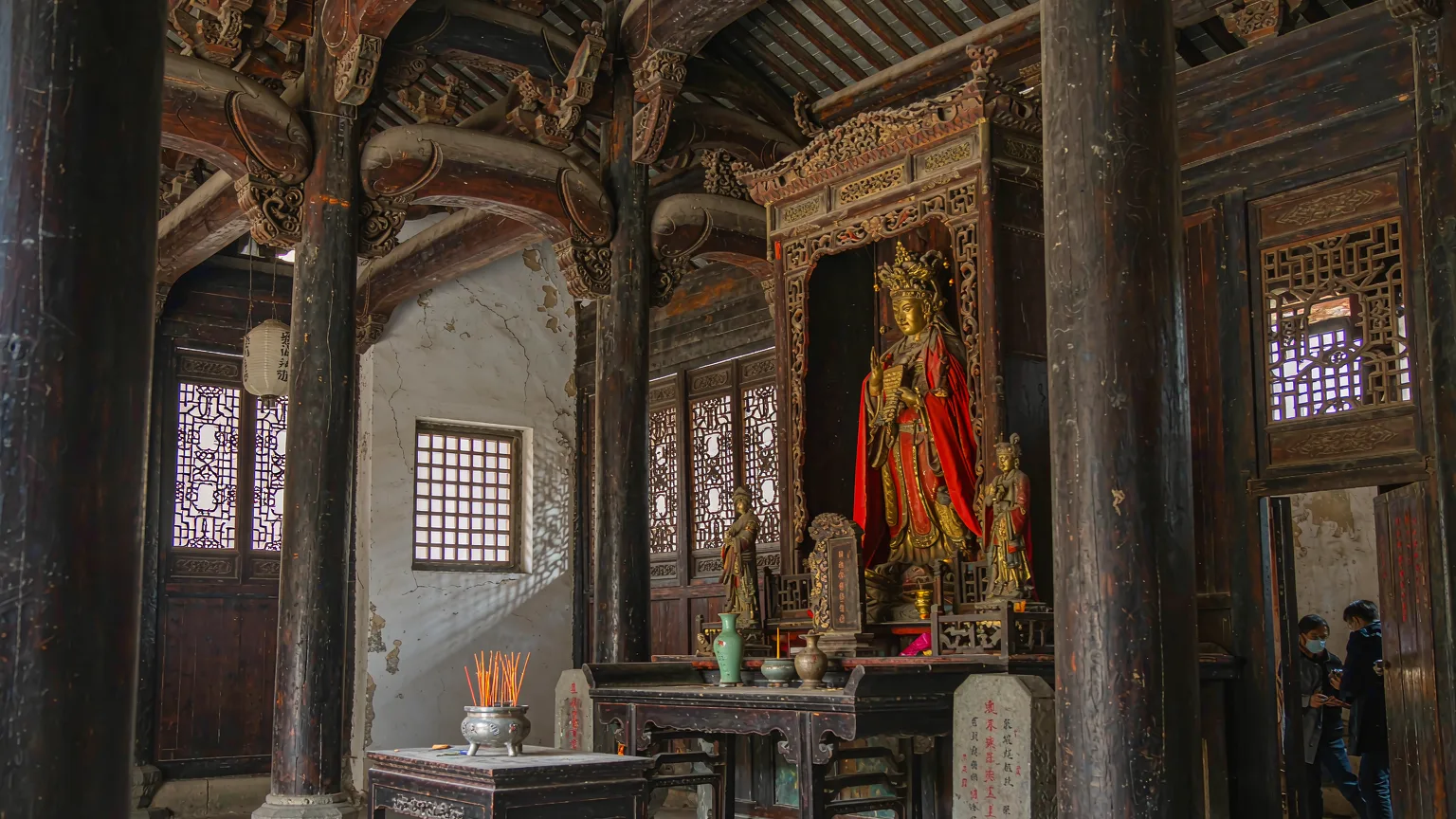 Interior of Wuyi Palace main hall with Taoist altar and carvings