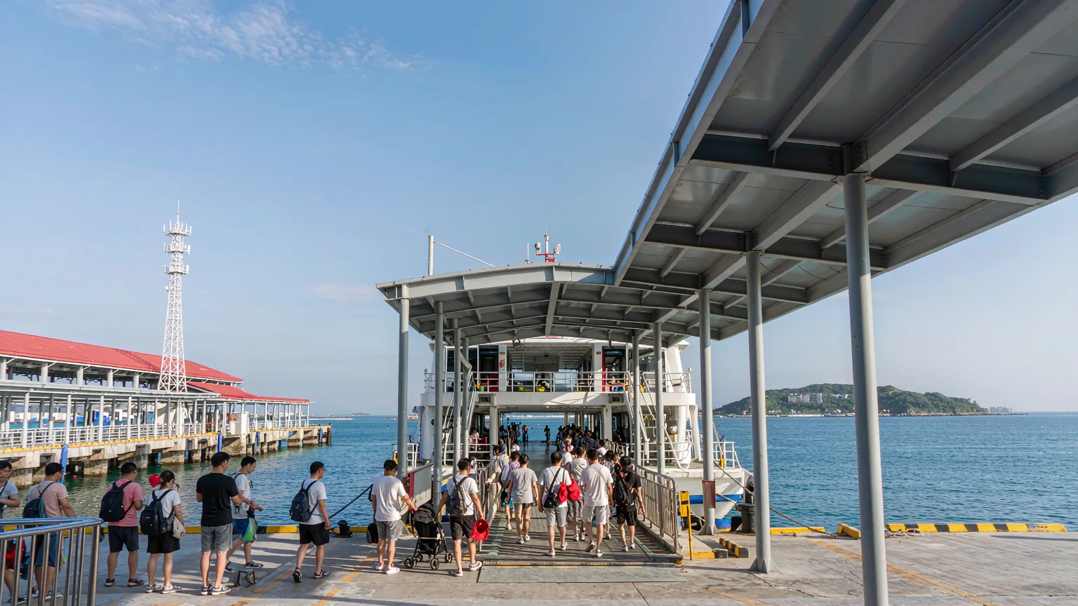 Tourists boarding a ferry to Wuzhizhou Island from Haitang Bay pier