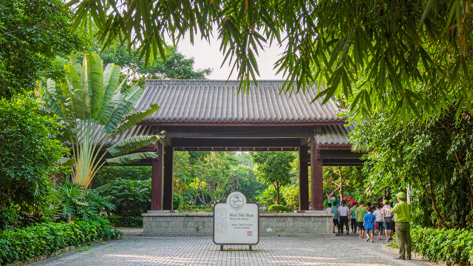 Tourists at the main entrance of Xiamen Botanical Garden with guide