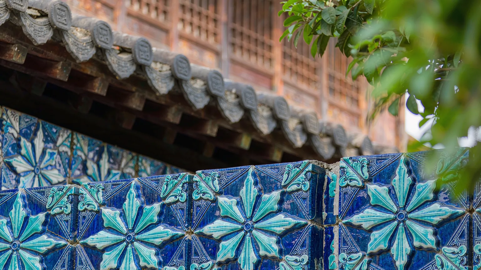 Close-up of intricate blue and turquoise glazed tiles at Xiangfei Garden