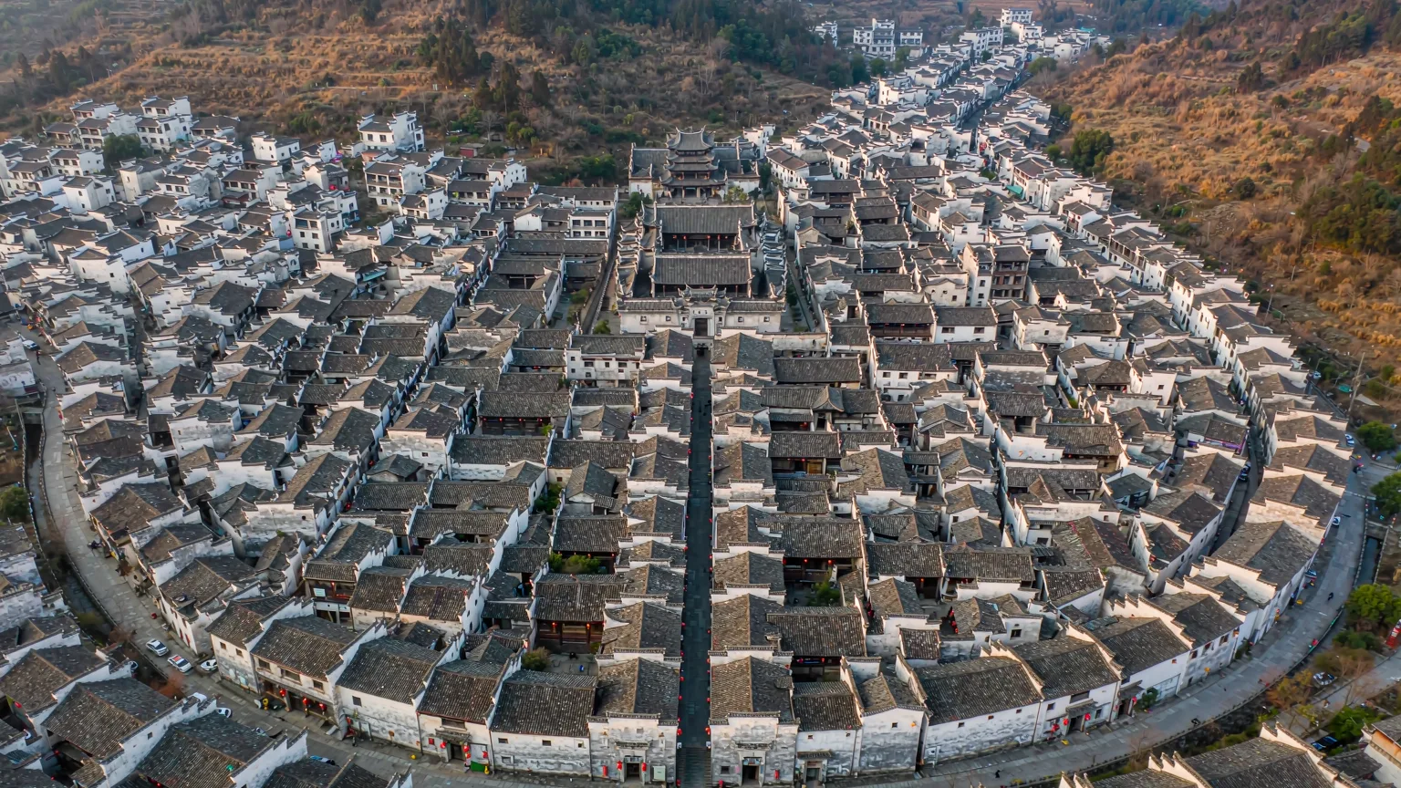 Aerial view of Xidi's boat-shaped layout with white houses and black roofs