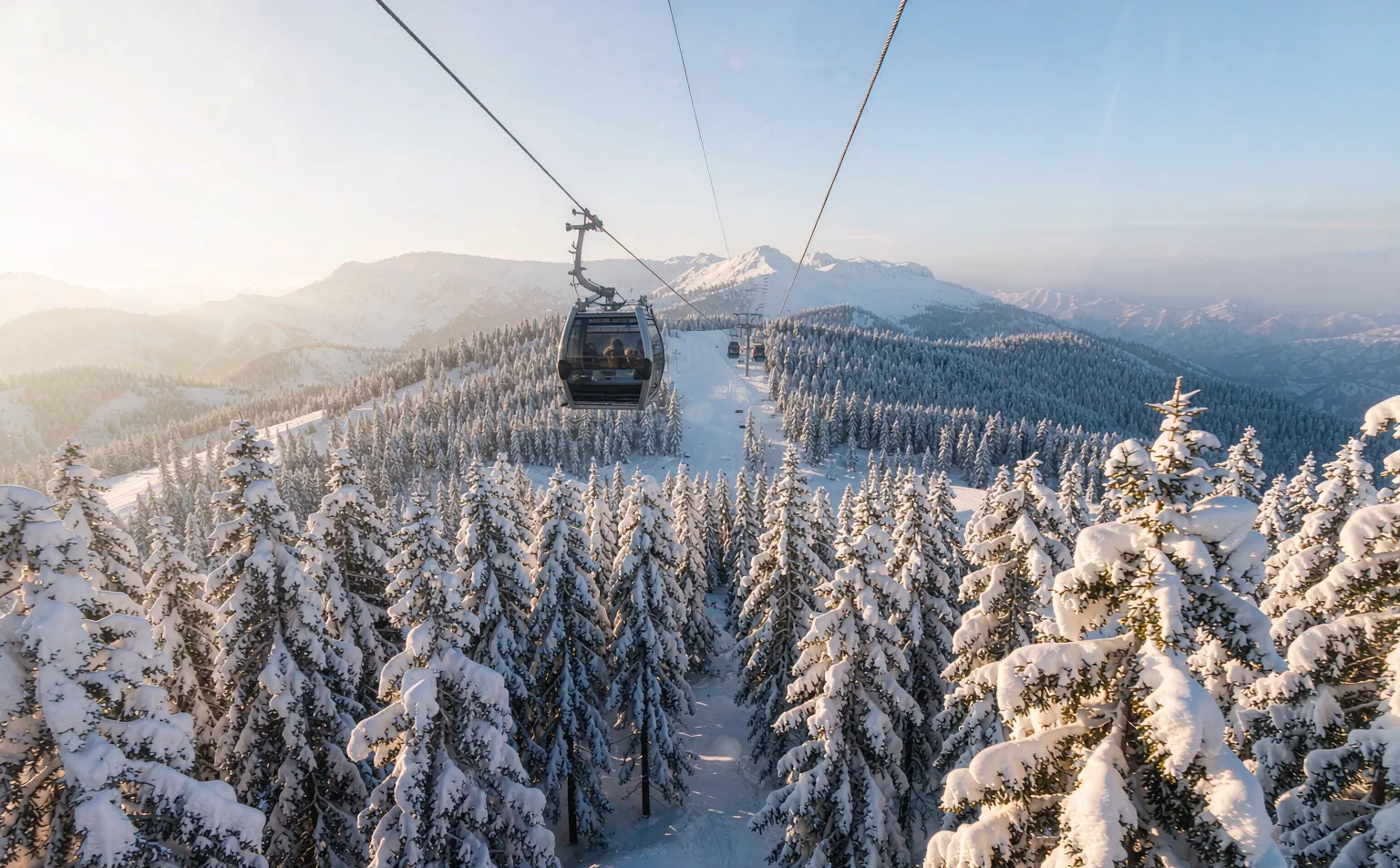 Cable car rising above the snowy forest of Xiling Snow Mountain