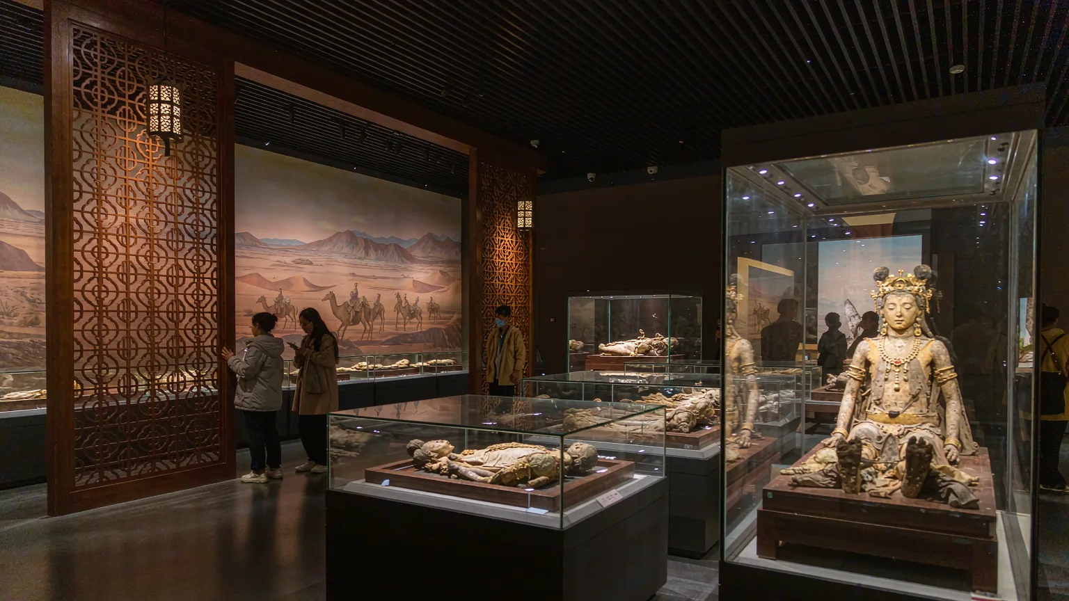 Ancient mummy gallery inside Xinjiang Museum with illuminated display cases