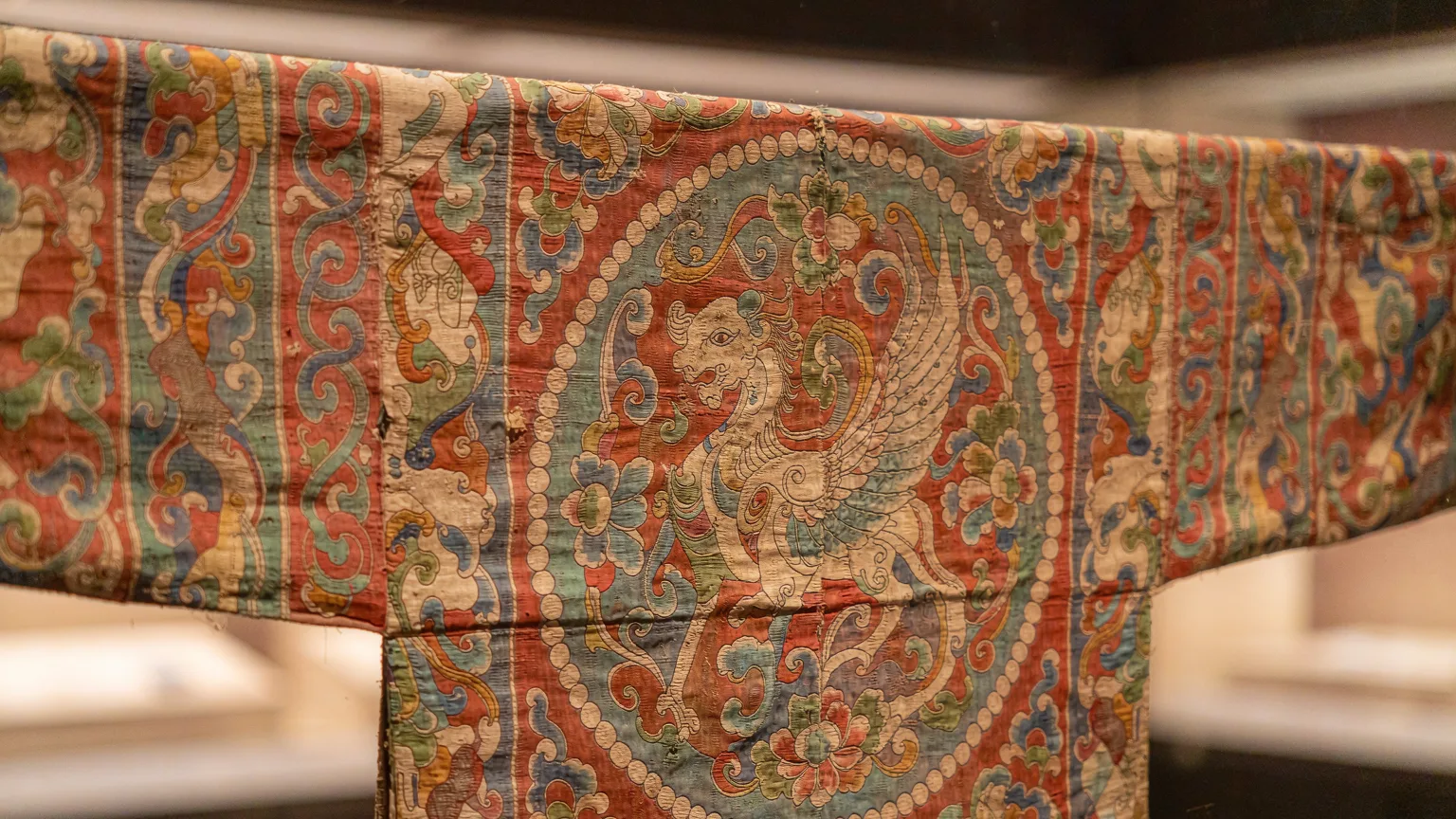 Close-up of ancient silk textile artifact in Xinjiang Museum