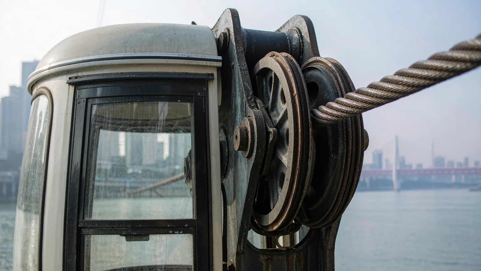 Detailed view of Yangtze River Cableway's cable and cabin mechanism with river backdrop