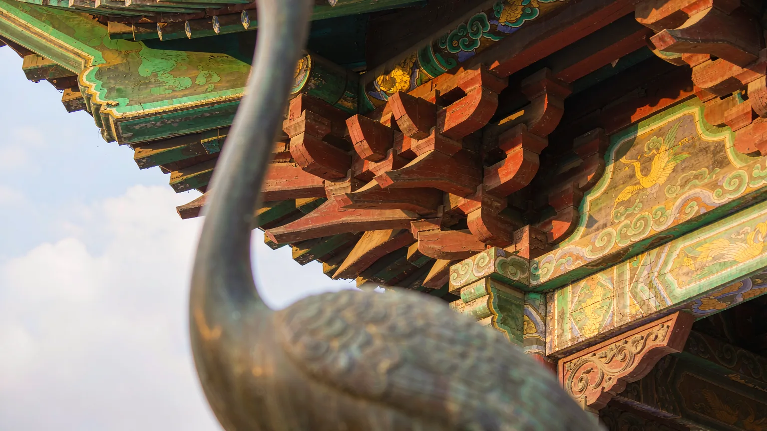 Detailed painted eaves and crane motifs on Yellow Crane Tower's upper gallery