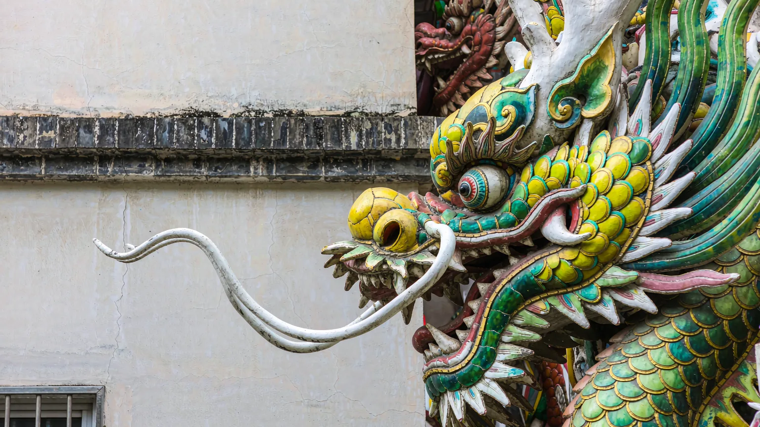 Intricate dragon head sculpture on Yu Garden's dragon wall