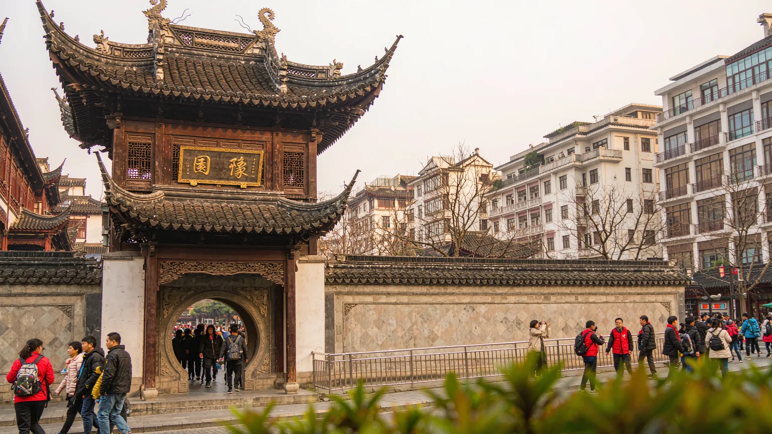 Visitors entering Yu Garden through traditional moon gate in Shanghai