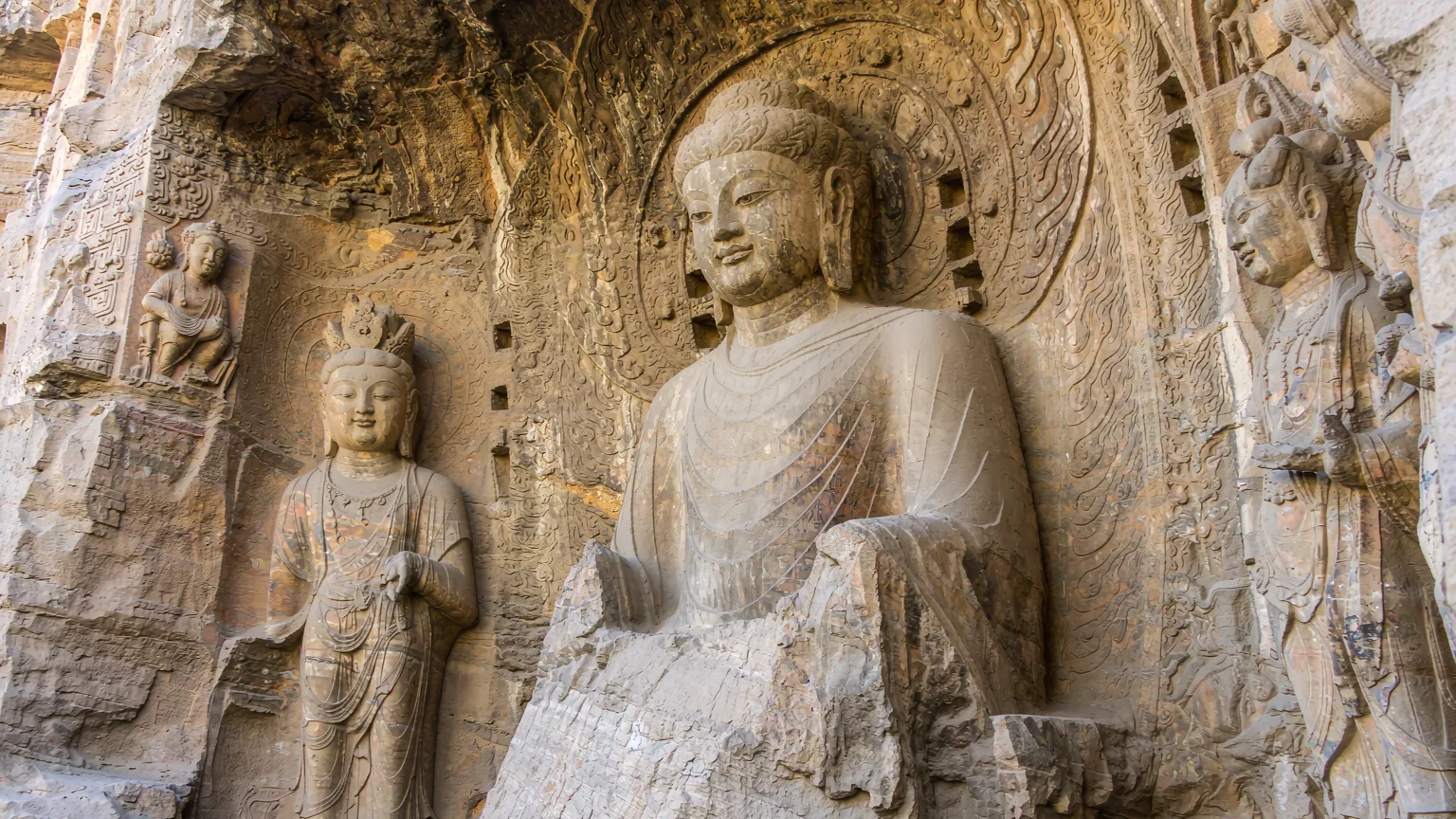 Detailed carvings of apsaras and motifs on Yungang Grottoes wall