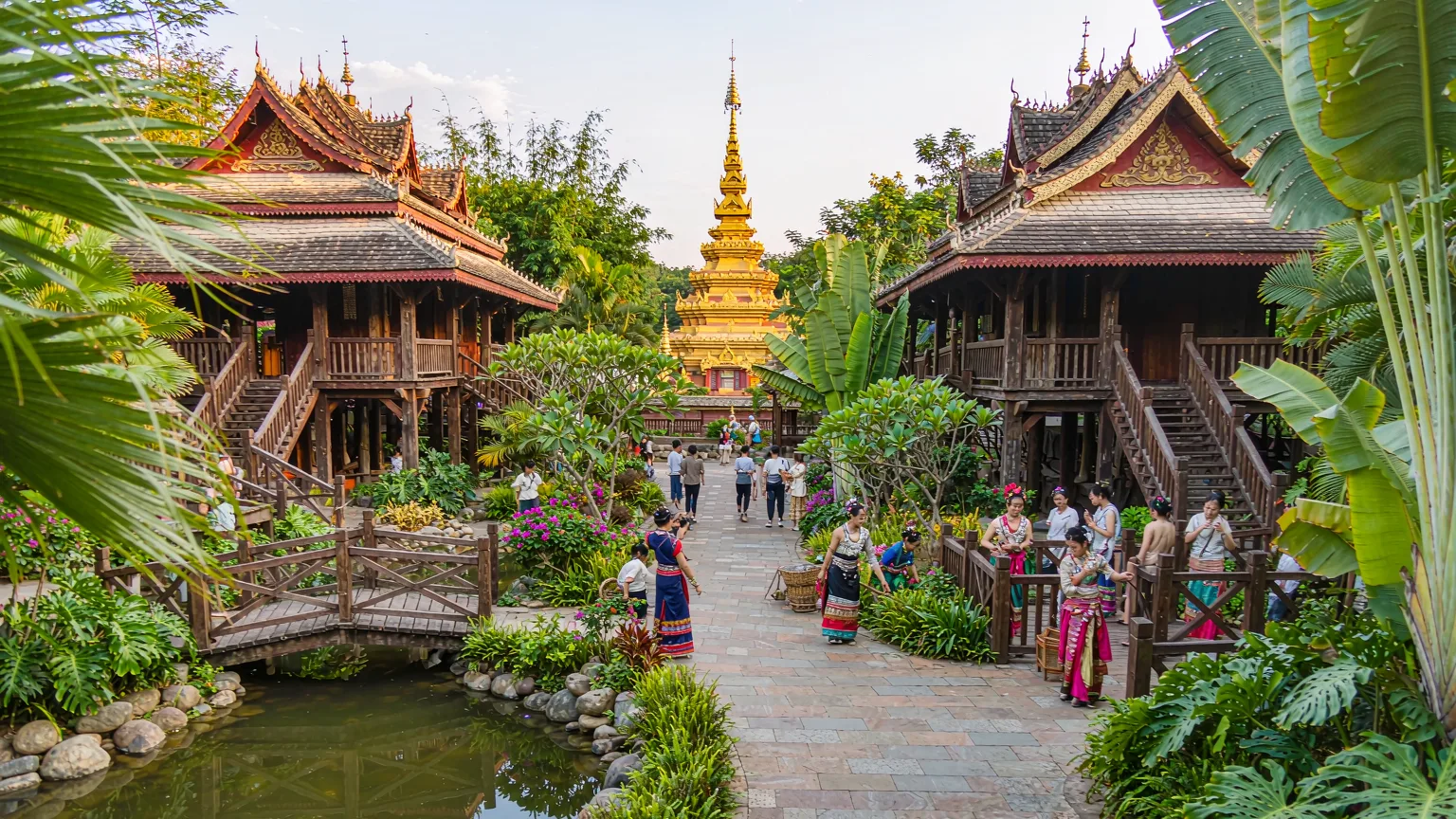 Dai stilt houses and golden pagoda at Yunnan Nationalities Village.
