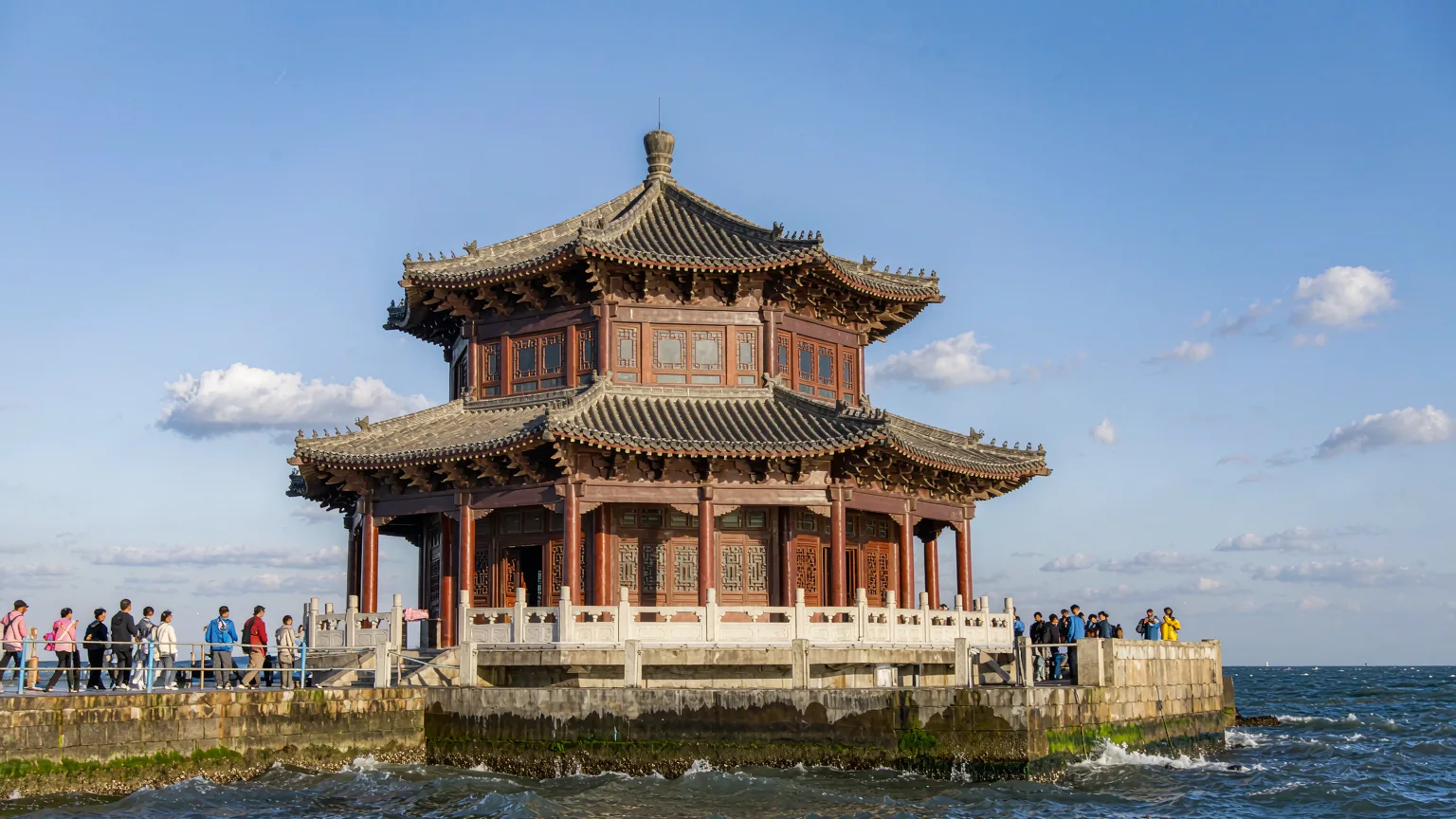Huilan Pavilion on Zhanqiao Pier, Qingdao, with visitors strolling