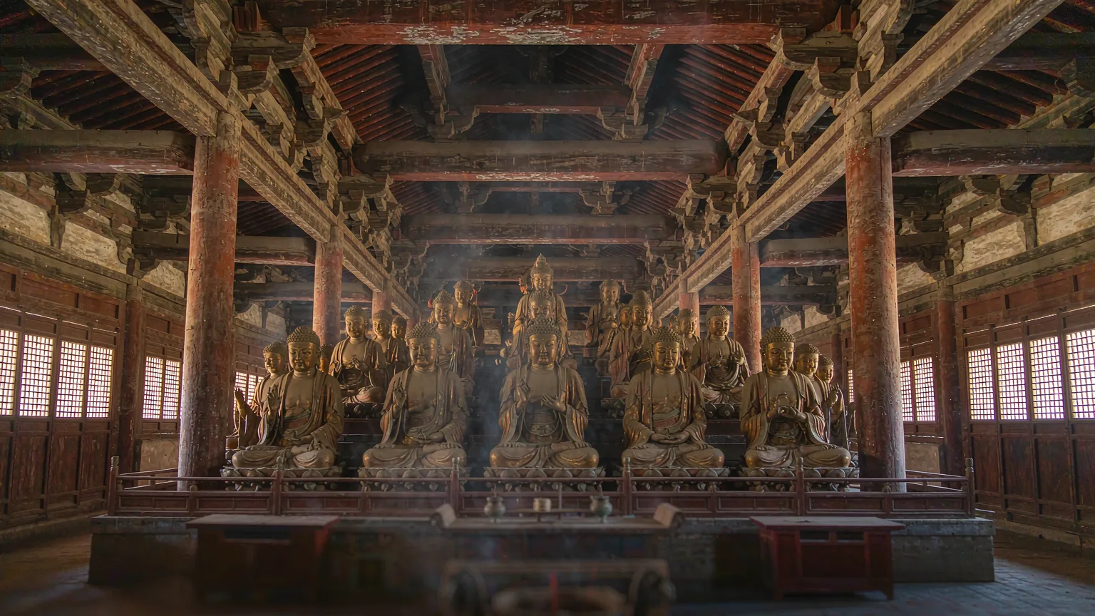 Serene sculpted Buddhas inside the ancient timber hall of Zhenguo Temple